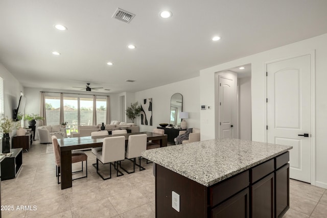 kitchen with dark brown cabinetry, open floor plan, recessed lighting, and visible vents