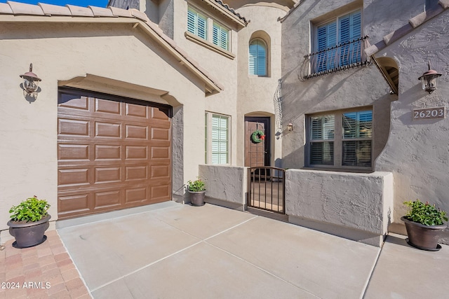 view of exterior entry with a garage