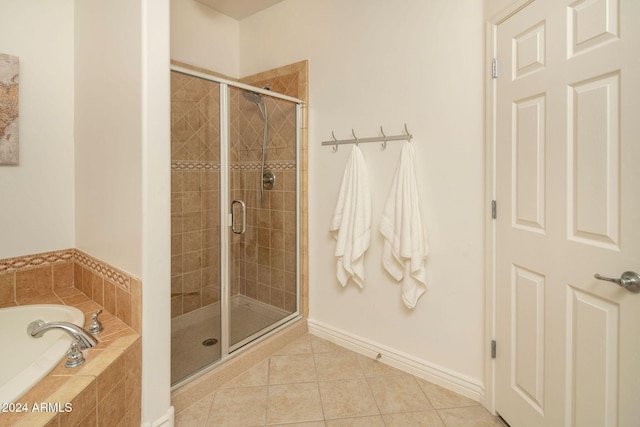 bathroom featuring tile patterned flooring and independent shower and bath