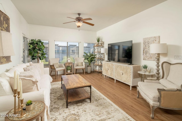 living room featuring ceiling fan and light hardwood / wood-style flooring