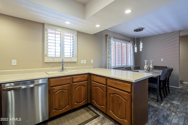 kitchen with a peninsula, dark wood-style flooring, a sink, light countertops, and dishwasher