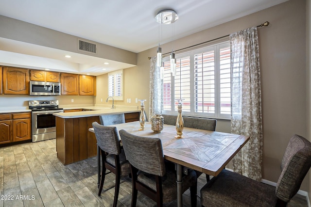 dining area featuring light wood-type flooring, visible vents, baseboards, and recessed lighting