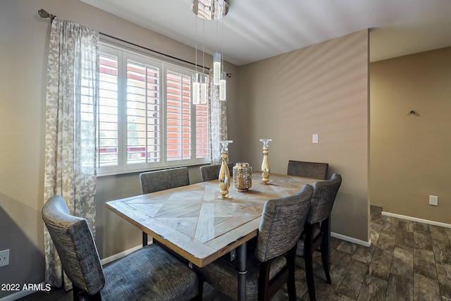 dining area featuring wood finished floors and baseboards