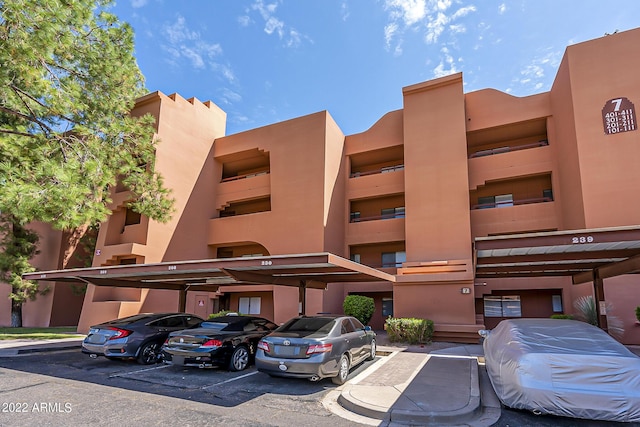 view of building exterior featuring covered parking