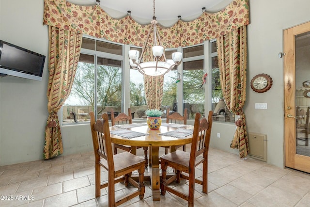 dining room with a wealth of natural light and a notable chandelier