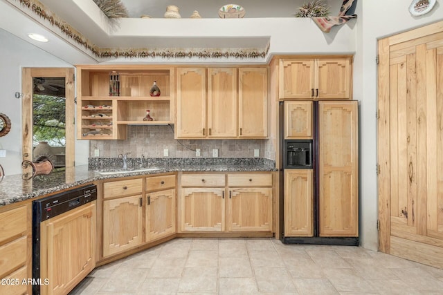 kitchen with paneled appliances, backsplash, light brown cabinetry, a sink, and dark stone counters