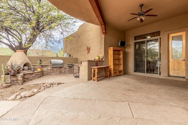 view of patio / terrace with an outdoor kitchen, a grill, and a ceiling fan