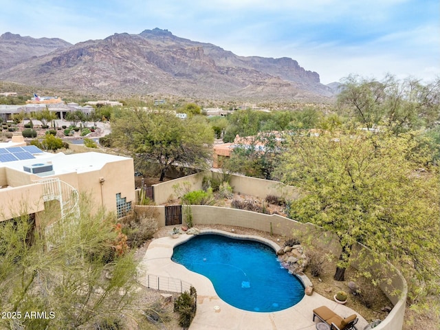 view of swimming pool with a fenced backyard, a mountain view, and a fenced in pool