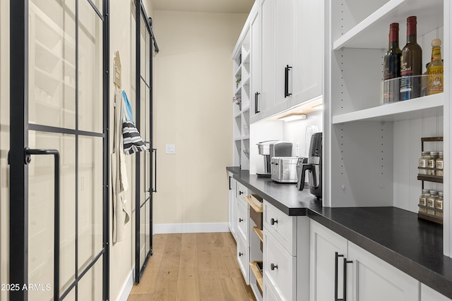 kitchen featuring white cabinets and light wood-type flooring