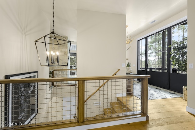 interior space featuring hardwood / wood-style floors and a chandelier