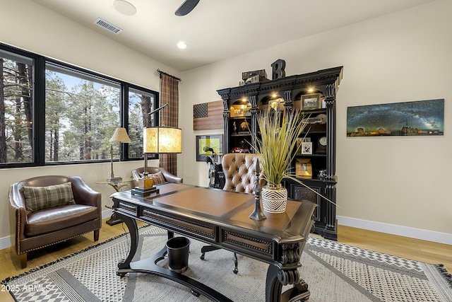 home office with hardwood / wood-style flooring