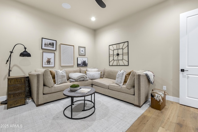 living room featuring ceiling fan and light hardwood / wood-style flooring