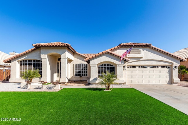 mediterranean / spanish home with a garage and a front yard