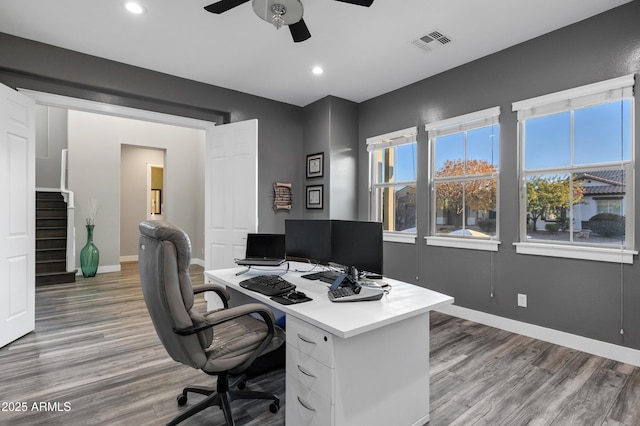 home office featuring wood-type flooring and ceiling fan