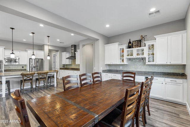 dining space with hardwood / wood-style floors