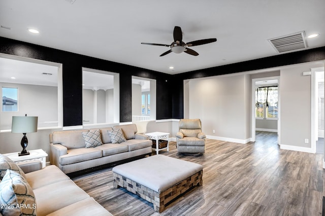 living room featuring ceiling fan and wood-type flooring