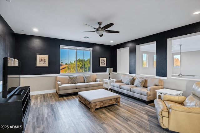 living room featuring hardwood / wood-style flooring and ceiling fan