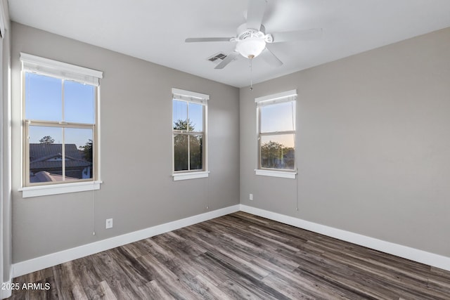 empty room featuring ceiling fan and dark hardwood / wood-style flooring