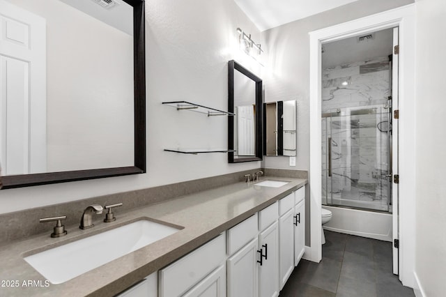 full bathroom with vanity, bath / shower combo with glass door, and toilet