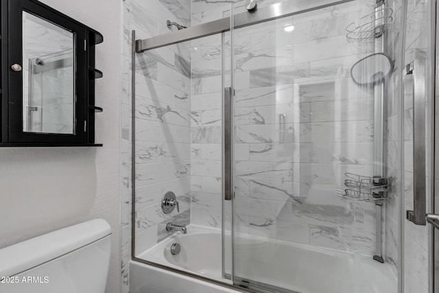 bathroom with shower / bath combination with glass door and toilet