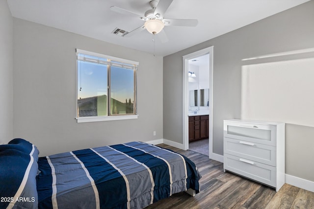 bedroom featuring ceiling fan, ensuite bathroom, and dark hardwood / wood-style flooring