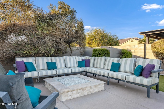 view of patio with an outdoor living space with a fire pit