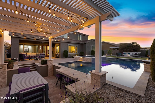 pool at dusk with an in ground hot tub, outdoor lounge area, a patio area, and a pergola