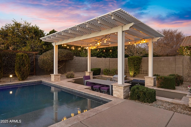 pool at dusk with area for grilling, a pergola, and a patio area