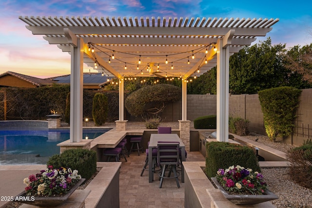 patio terrace at dusk featuring a fenced in pool and a pergola