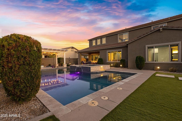 pool at dusk featuring an in ground hot tub, a yard, and a patio