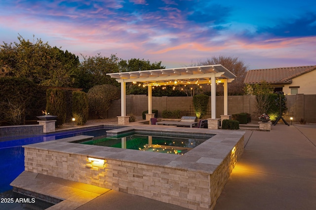 pool at dusk with a pergola, a patio, and an in ground hot tub