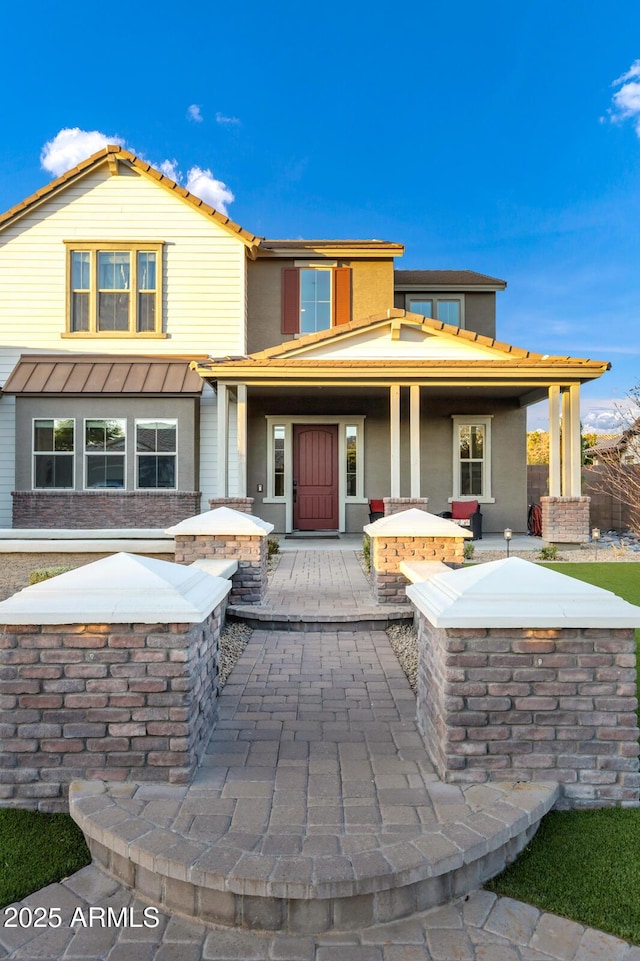 back of house featuring a porch