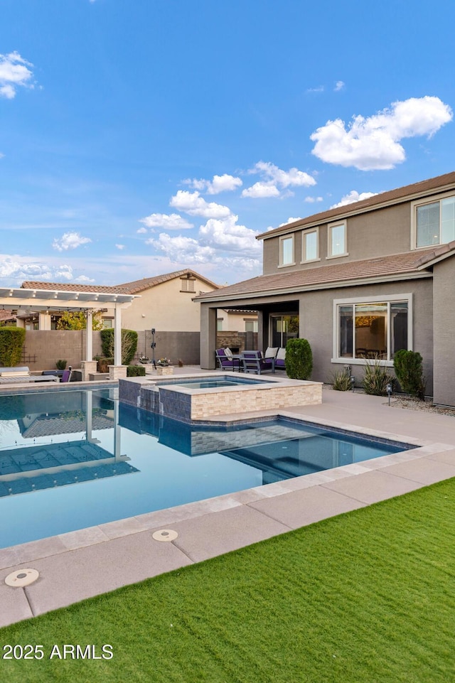 view of pool with an in ground hot tub, a yard, and a patio area