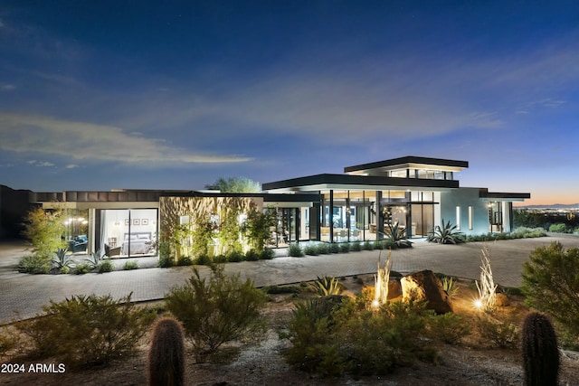 view of back of property at dusk