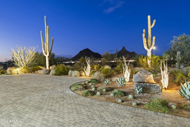 surrounding community with decorative driveway and a mountain view