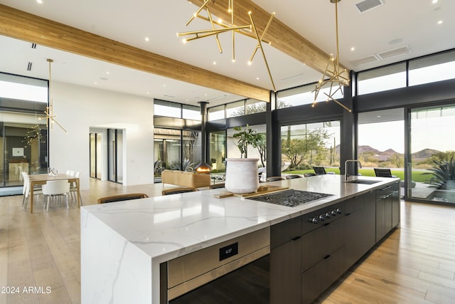 kitchen featuring a mountain view, a sink, open floor plan, a large island, and expansive windows