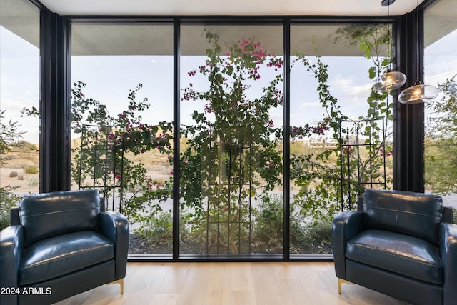 interior space with floor to ceiling windows and light wood-style flooring