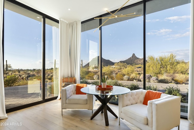 sunroom with plenty of natural light and a mountain view