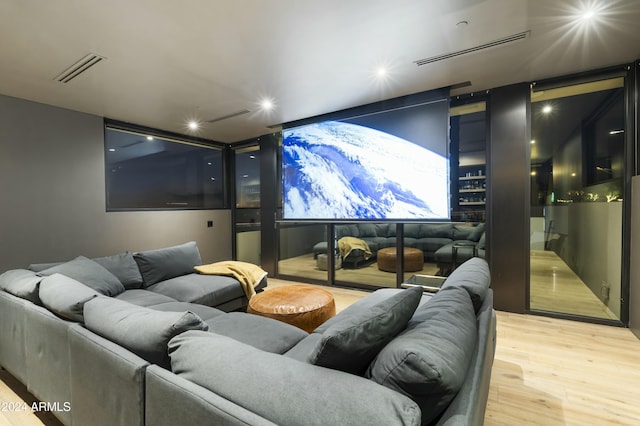 home theater room featuring visible vents and wood finished floors