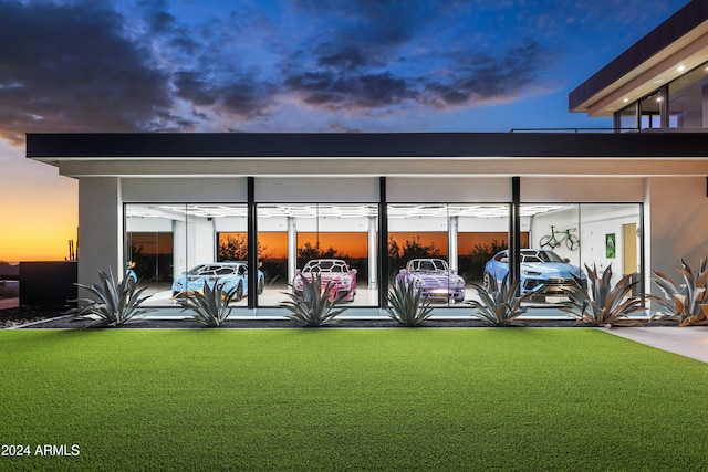 exterior space featuring uncovered parking, a yard, and stucco siding