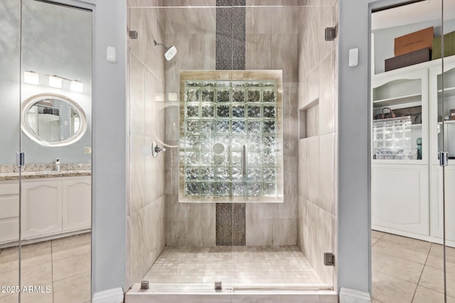 bathroom featuring a shower stall and tile patterned flooring