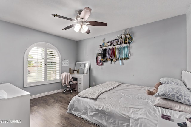 bedroom with baseboards, dark wood-type flooring, and ceiling fan