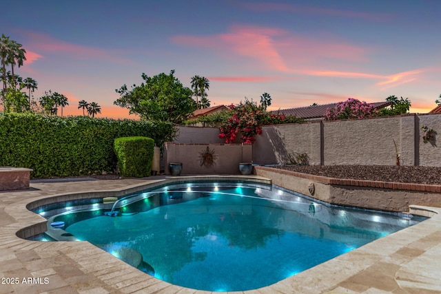 view of pool with a fenced backyard