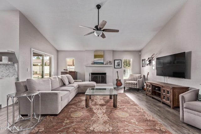 living room with vaulted ceiling, a ceiling fan, plenty of natural light, and wood finished floors