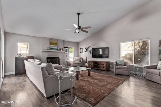 living room with a ceiling fan, a healthy amount of sunlight, wood finished floors, and a fireplace