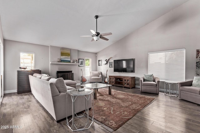 living room with wood finished floors, a fireplace, ceiling fan, and a healthy amount of sunlight