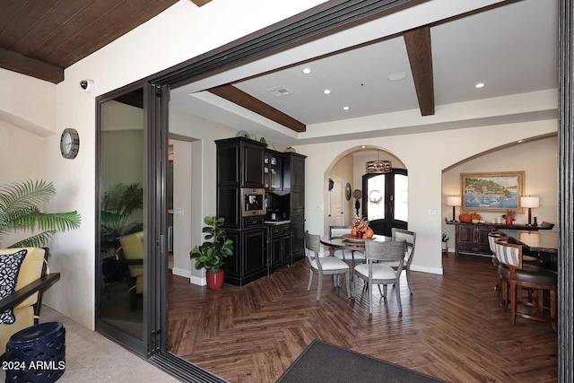 dining room featuring beamed ceiling and parquet floors