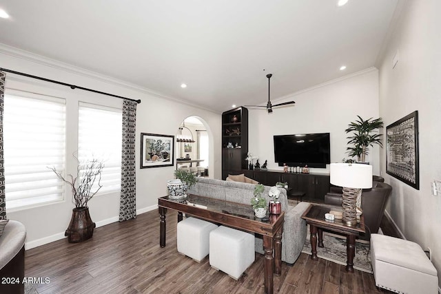 living room featuring ceiling fan, dark wood-type flooring, and ornamental molding