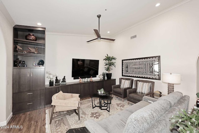 living room with ceiling fan, light hardwood / wood-style floors, and ornamental molding