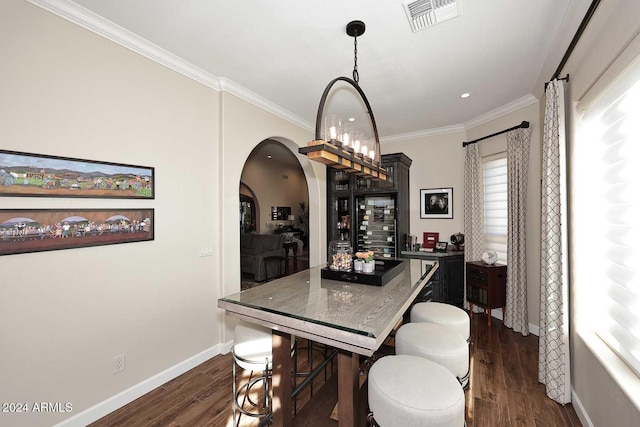 dining area with dark hardwood / wood-style flooring and crown molding